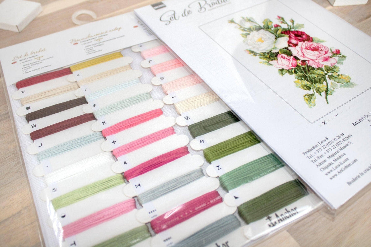 Color swatch book with fabric samples and a floral design on a wooden surface