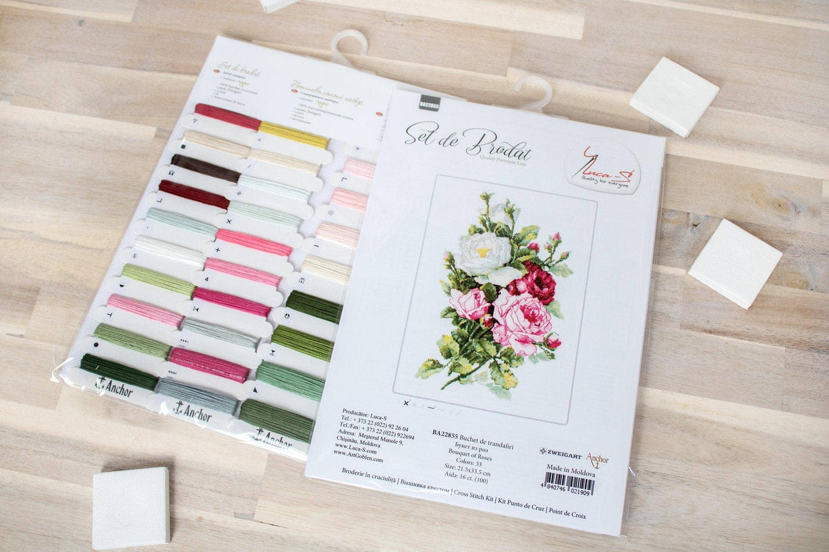 Set of embroidery threads with color chart on a wooden surface