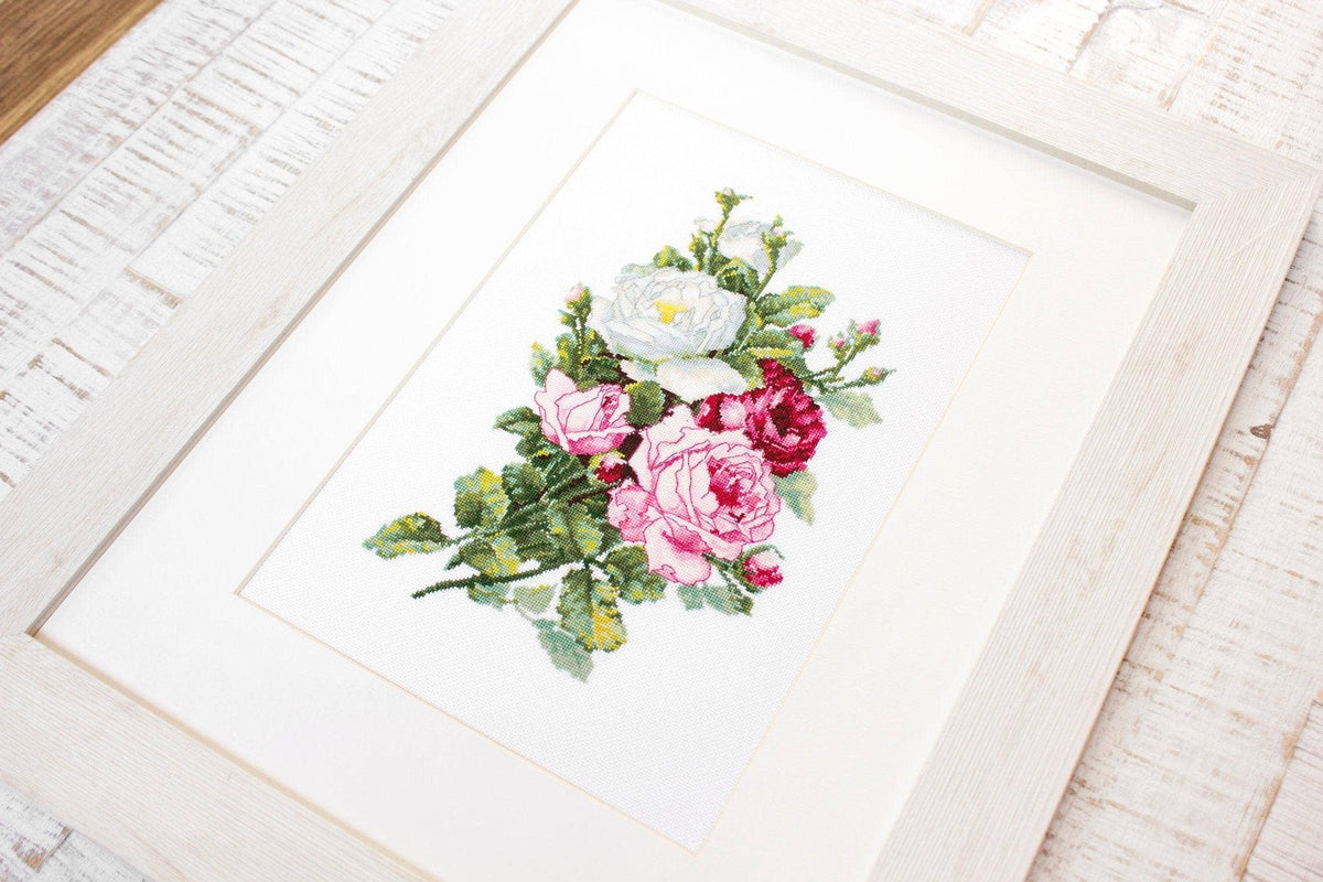 Framed artwork of a floral arrangement on a white surface