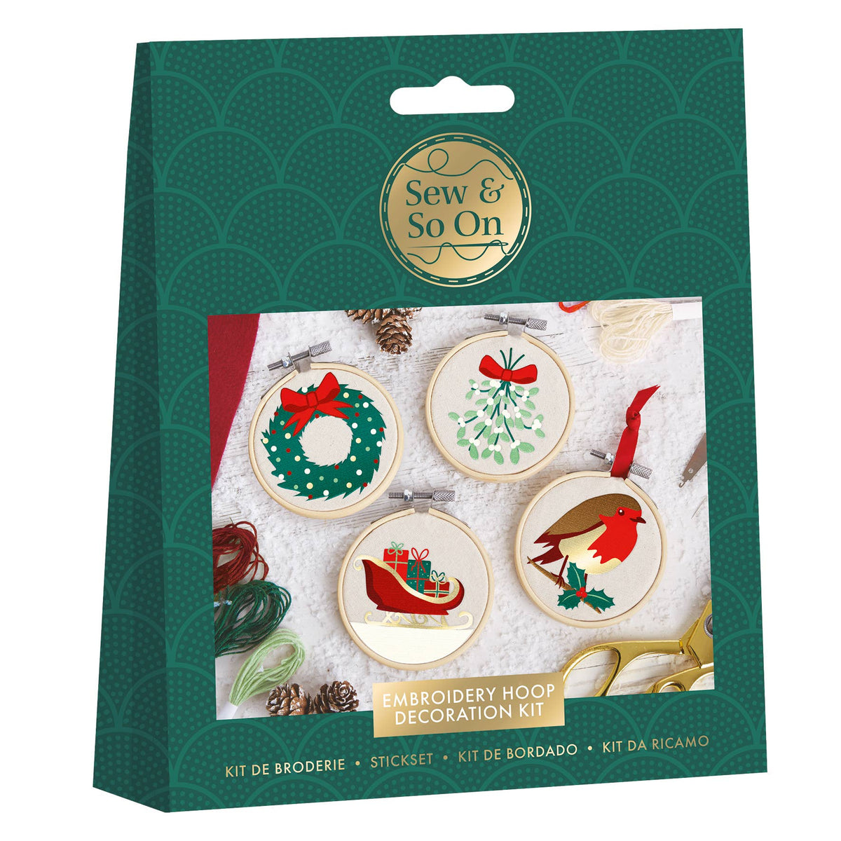 Embroidery hoop decoration kit packaging with Christmas-themed designs on a green background.